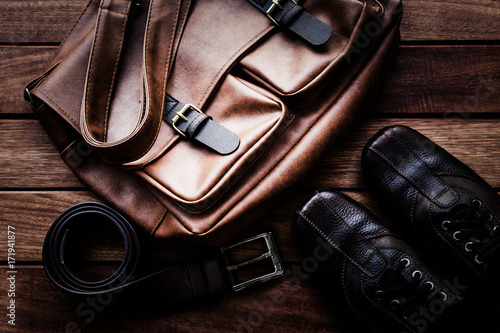 Men's leather accessories on rustic wooden background, fashion and beauty, travel concept