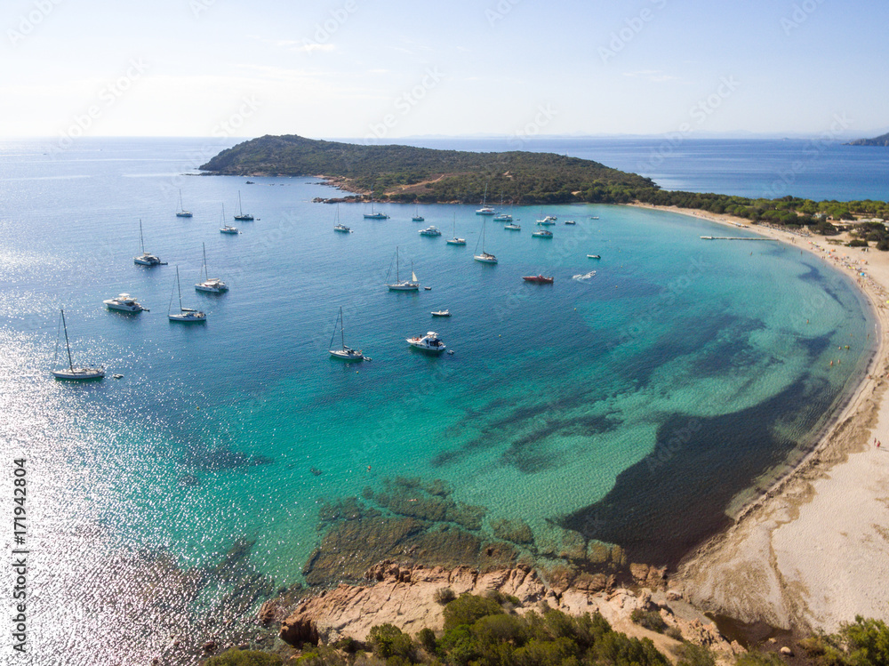 Aerial drone view of Rondinara Bay Beach Corsica with boats