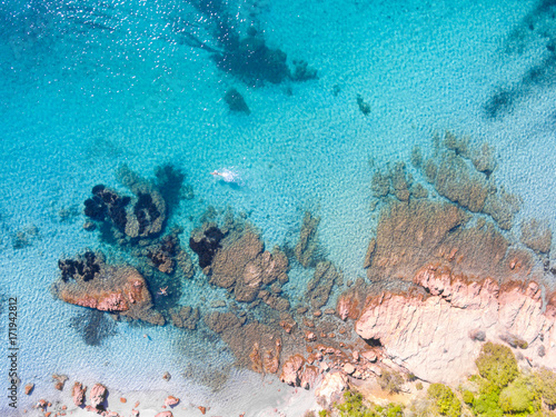 Aerial drone view of a swimmer swimming near the beach
