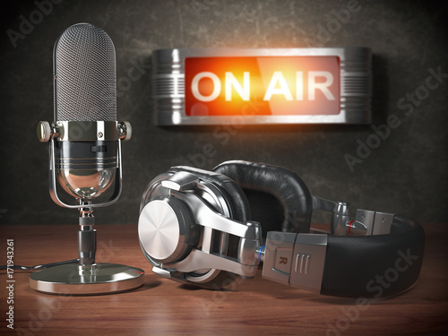 Vintage microphone  and headphones with signboard on air. Broadcasting radio station concept. photo