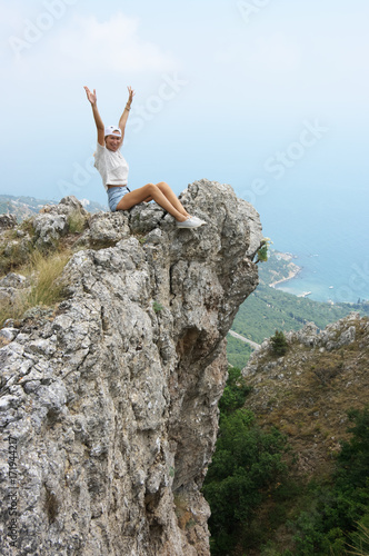 Young woman on top of mountain