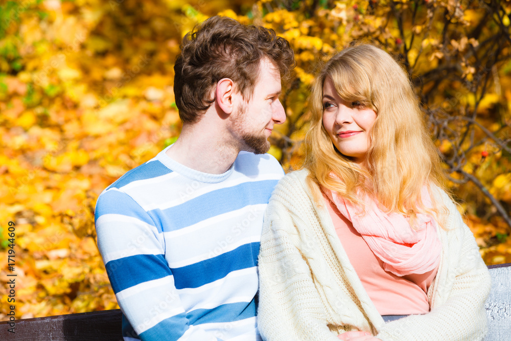 Lovers couple in autumn park on bench Lovers couple in autumn park on bench