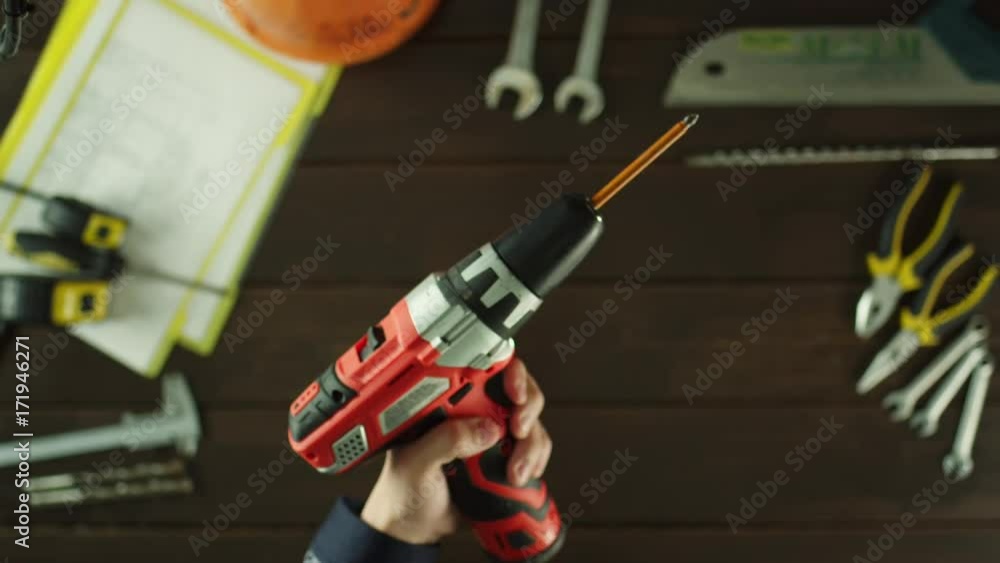 Top view of a guy checking a drill Top view of a guy checking a drill