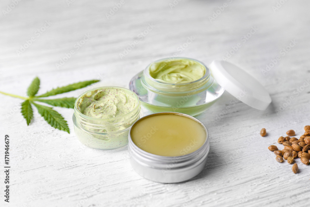 Cosmetics with hemp extract on white wooden background Cosmetics with hemp extract on white wooden background