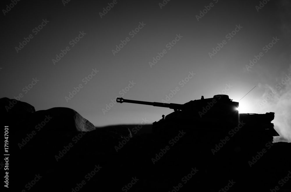 War Concept. Military silhouettes fighting scene on war fog sky background, World War Soldiers Silhouettes Below Cloudy Skyline At sunset. Attack scene. German tank in action