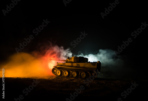 War Concept. Military silhouettes fighting scene on war fog sky background, German tank in action Below Cloudy Skyline At night. Attack scene. Armored vehicles