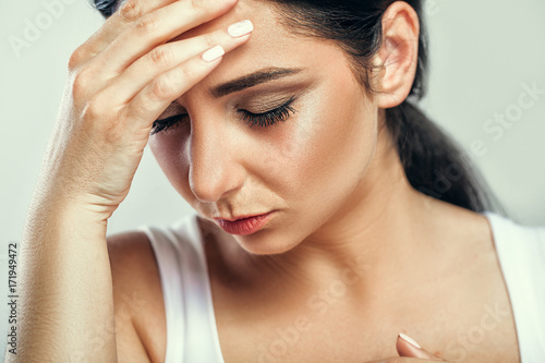 Health And Pain. Stressed Exhausted Young Woman Having Strong Tension Headache. Closeup Portrait Of Beautiful Sick Girl Suffering From Head Migraine, Feeling Pressure And Stress. High Resolution Image