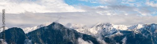 panoramic view of the mountains near Chur in the Alps in Switzerland after snow fall and with cloudy sky