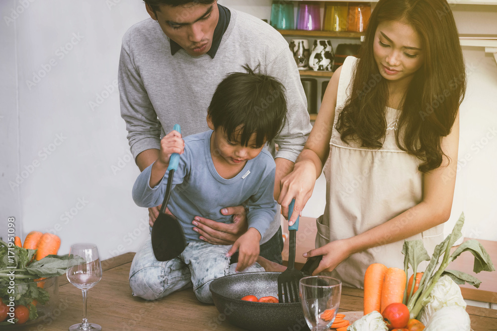 Families are happy to cook together in the kitchen.