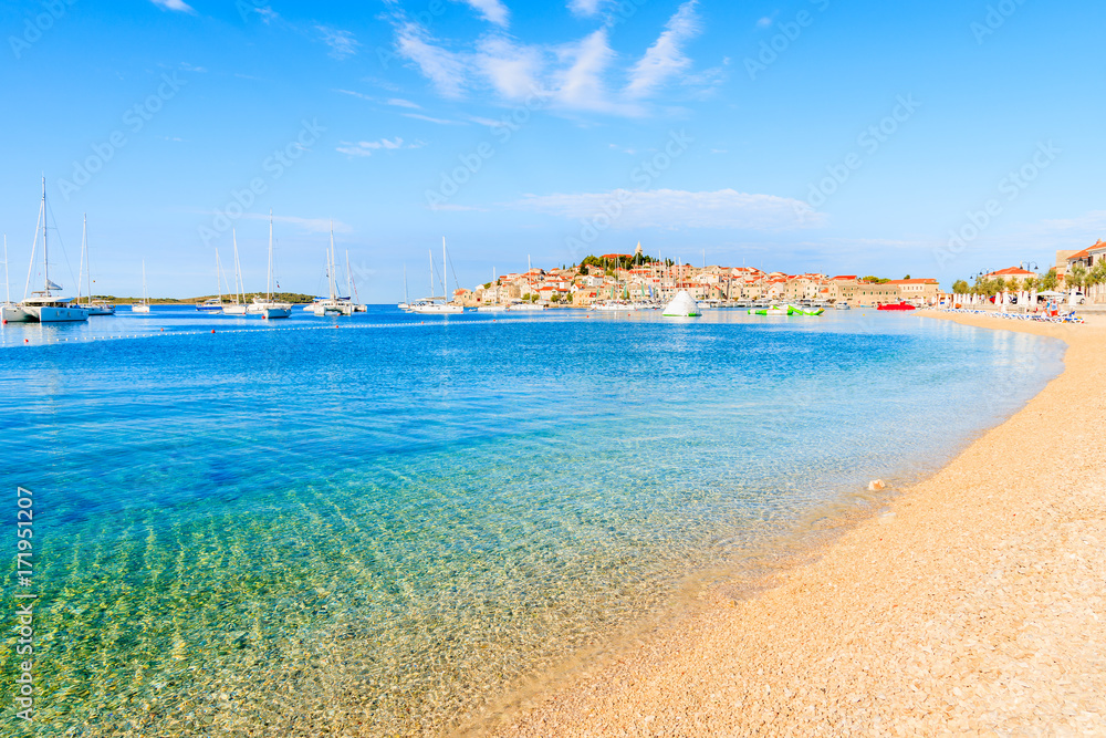 Beach with crystal clear sea water in Primosten town at early morning, Dalmatia, Croatia