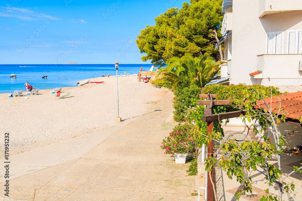 View of coastal path and beach in Primosten town, Dalmatia, Croatia