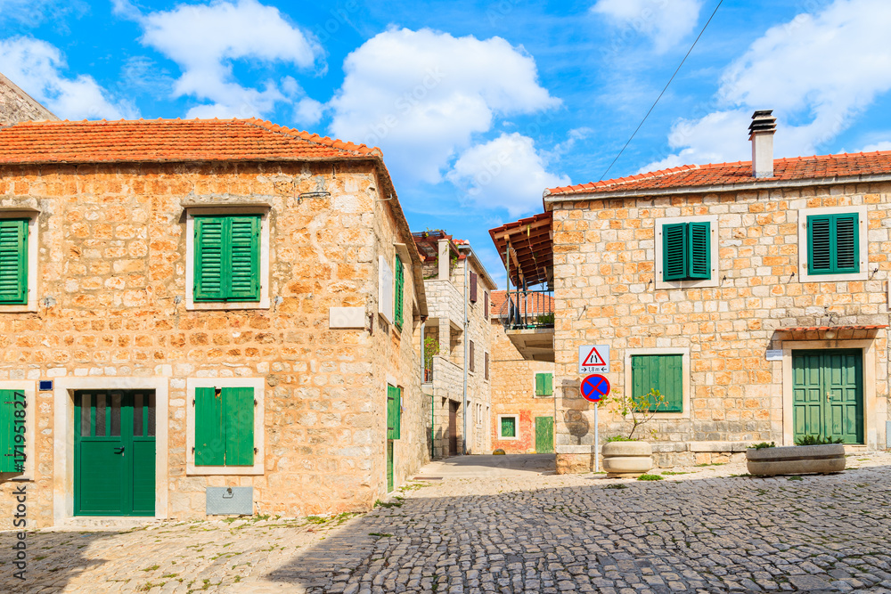 Street with typical stone houses in Postira old town, Brac island, Croatia