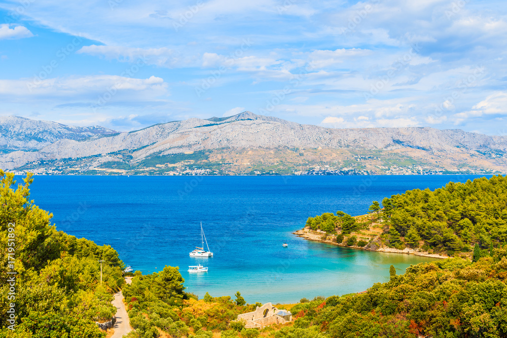 View of Lovrecina bay with sailing boats on blue sea, Brac island, Croatia