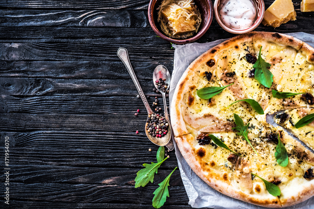 Delicious italian pizza on wooden background