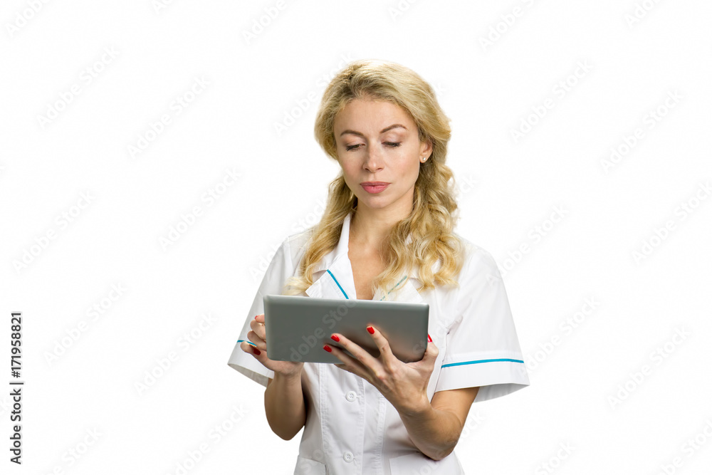 Portrait of young nurse with computer tablet. Pretty blond female doctor holding computer tablet on white background. Portrait of young nurse with computer tablet. Pretty blond female doctor holding computer tablet on white background.