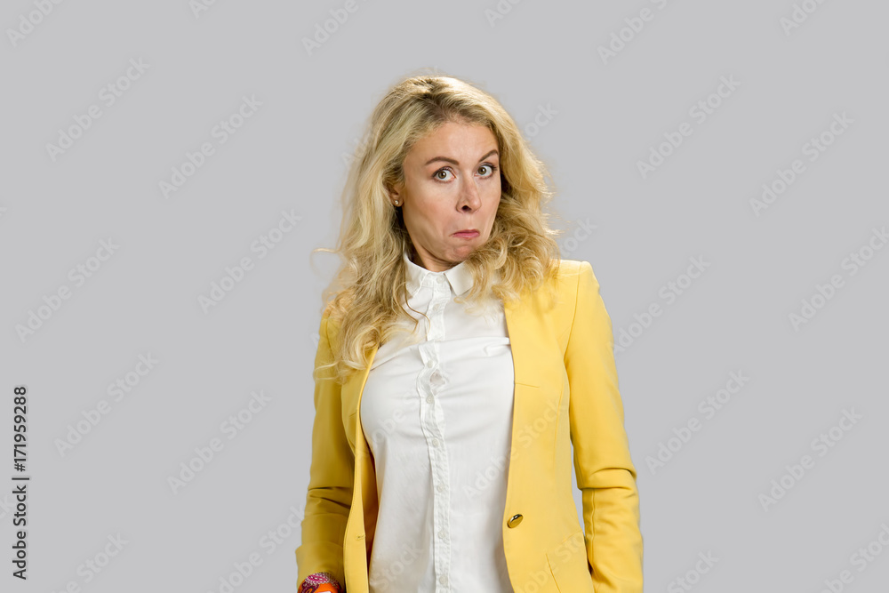 Surprised astonished funny young woman. Closeup portrait blonde woman looking surprised in with wide open eyes isolated on grey background. Surprised astonished funny young woman. Closeup portrait blonde woman looking surprised in with wide open eyes isolated on grey background.
