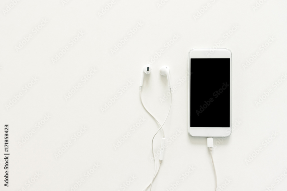 Minimal work space - Creative flat lay photo of workspace desk with earphones and mobile phone with blank screen on copy space white background. Top view mock up , flat lay photography. Minimal work space - Creative flat lay photo of workspace desk with earphones and mobile phone with blank screen on copy space white background. Top view mock up , flat lay photography.