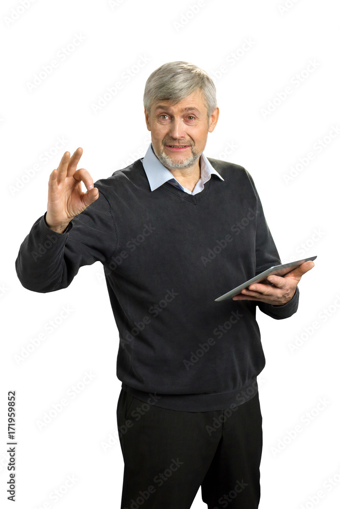 Handsome mature man showing Ok sign. Cheerful senior man in formal wear gesturing OK sign with fingers and holding computer tablet on white background. Handsome mature man showing Ok sign. Cheerful senior man in formal wear gesturing OK sign with fingers and holding computer tablet on white background.
