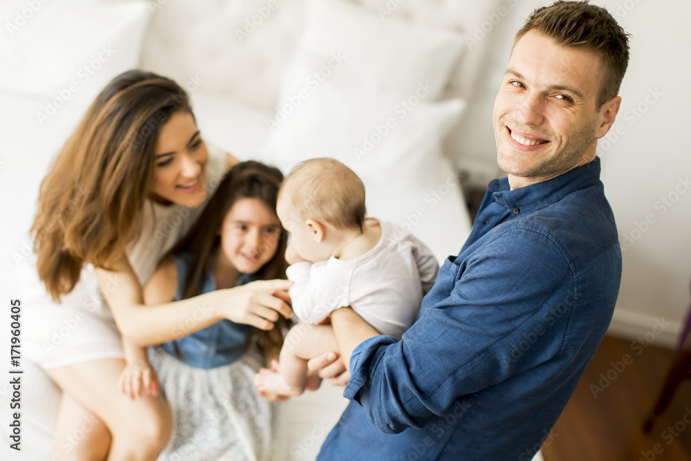 Young parents with daughters in the room Young parents with daughters in the room