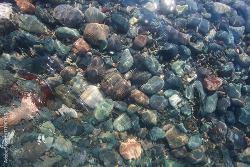 pebbles on the seabed transparent water