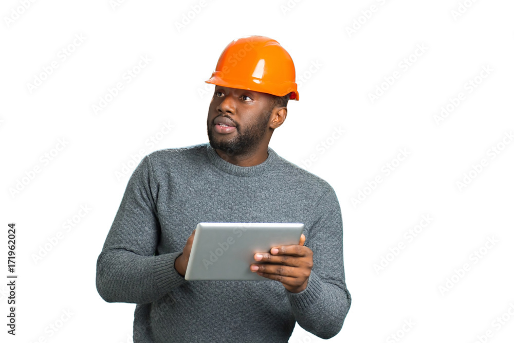 Architect with tablet looking on building. Cheerful young architect working on digital tablet and checking the object. Engineer compare object and project. Architect with tablet looking on building. Cheerful young architect working on digital tablet and checking the object. Engineer compare object and project.