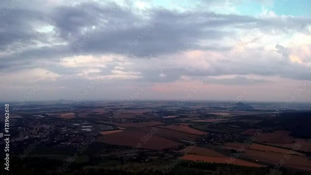 View from Lovos hill to czech highway D8 leading from Prague to Germany near Vchynice village with castle ruins Hazmburk in PLA Czech central mountains at sunset