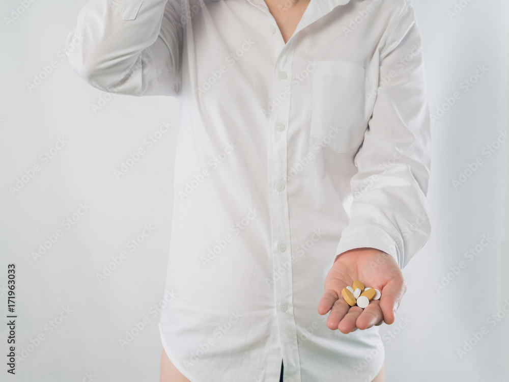 close up of human hand hold drug on isolated white background.