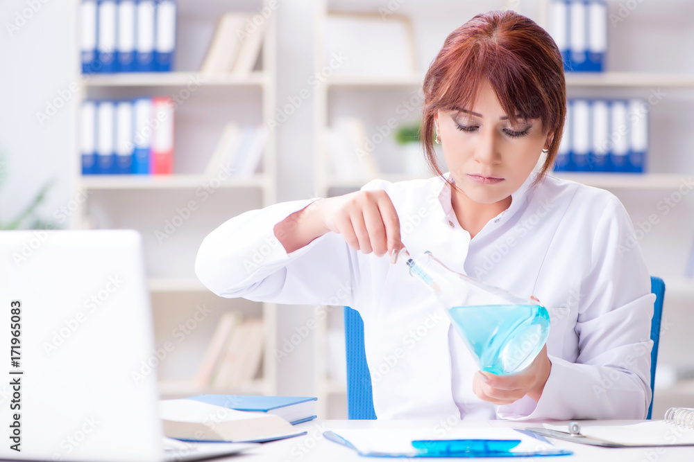 Female scientist researcher conducting an experiment in a labora Female scientist researcher conducting an experiment in a labora