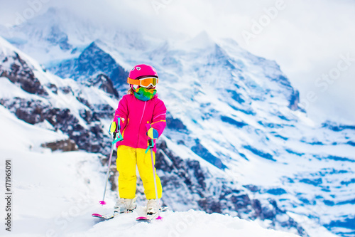 Ski and snow fun. Child in winter mountains.