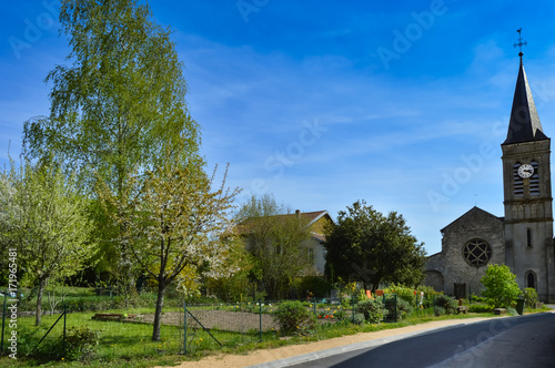 Small garden and old church in a small village © Demande Philippe