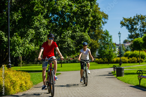 Wallpaper Mural Healthy lifestyle - people riding bicycles in city park  Torontodigital.ca