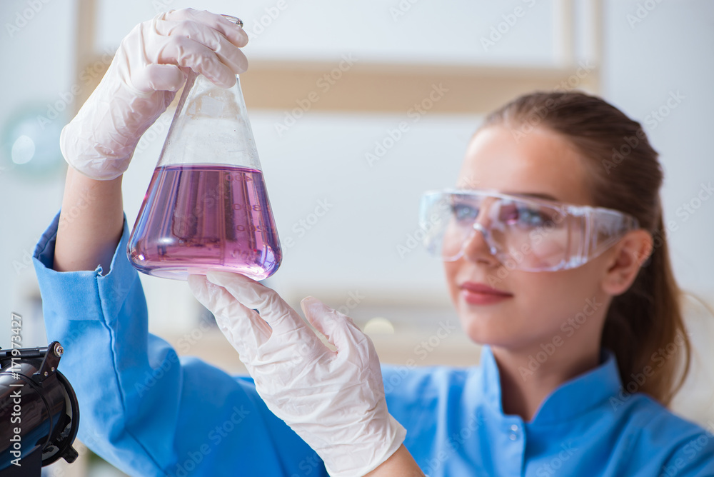 Female scientist researcher conducting an experiment in a labora Female scientist researcher conducting an experiment in a labora