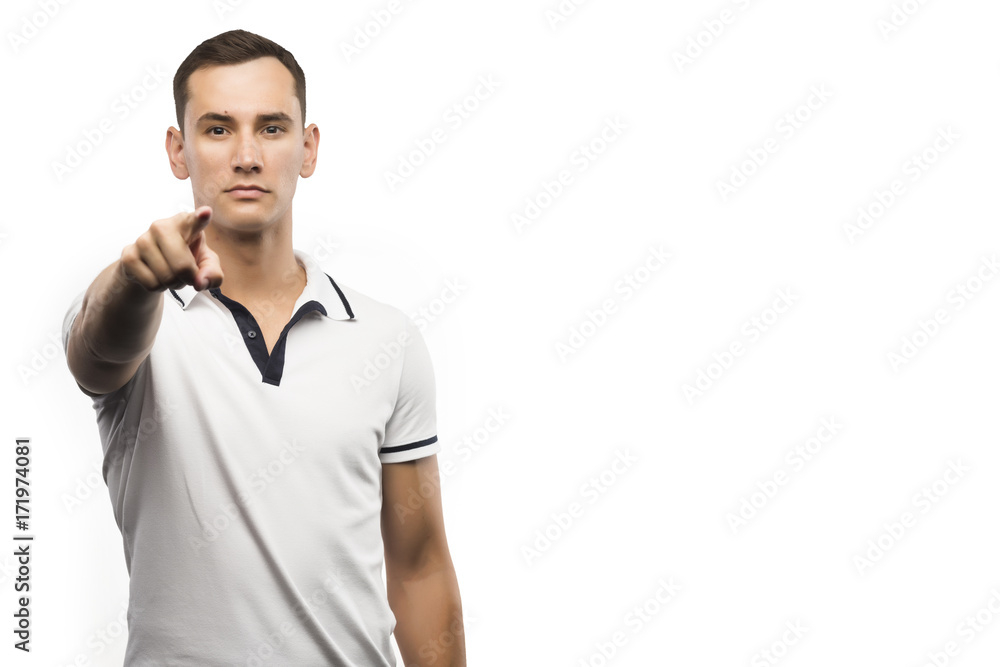 The young man points a finger isolated on a white The young man points a finger isolated on a white