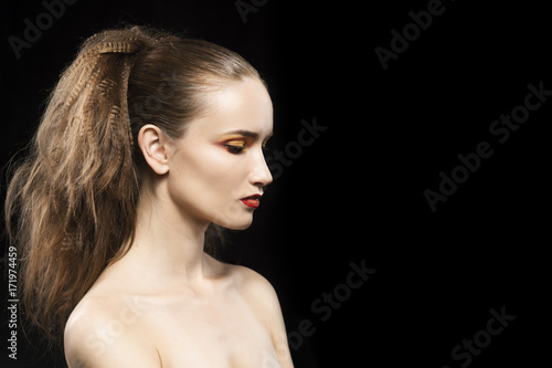 Portrait of the topless beautiful girl on a black background
