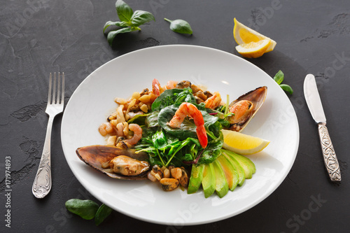 Warm salad with grilled seafood and cutlery