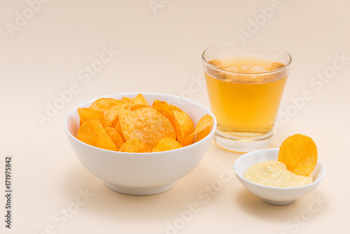 Cheese and onion potato chips with soft drink on table.