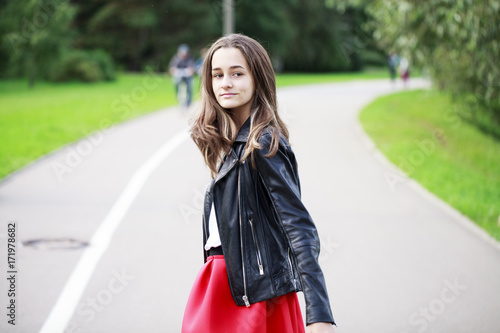 Brunette girl in the background of a summer park © Andrey_Arkusha