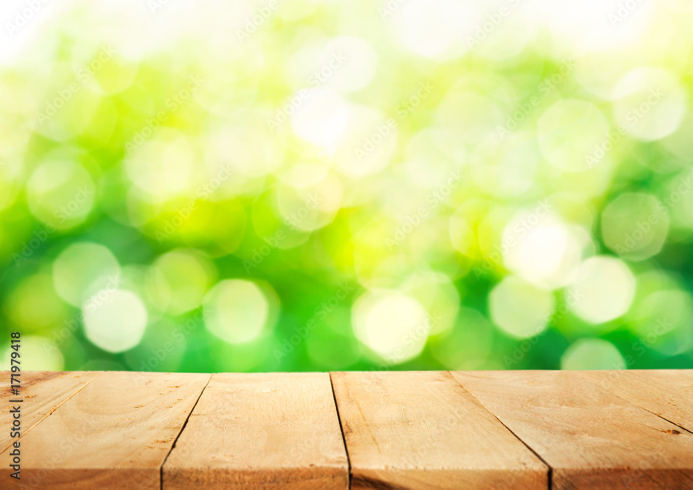 Empty of wood table top on blur of fresh green abstract background .For montage product display  key visual layout