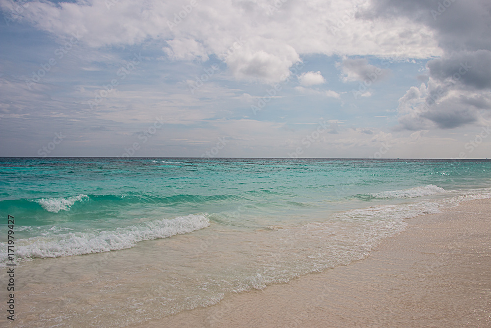 Fototapeta premium Beach and sea on the blue sky background.