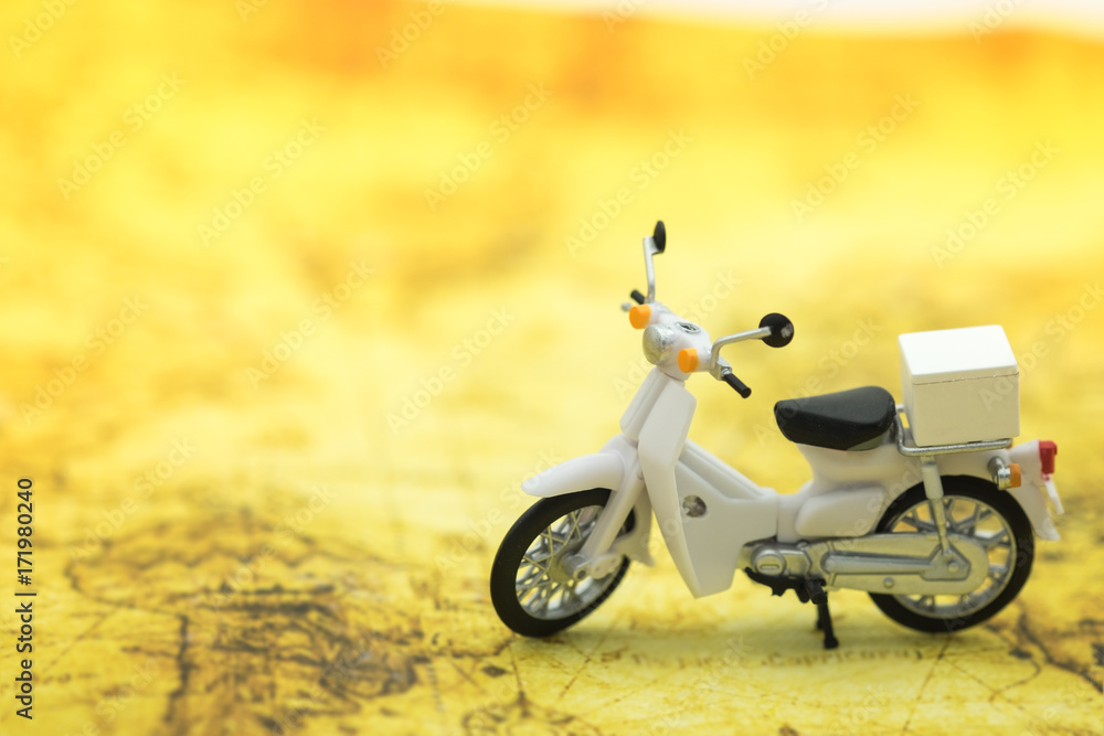 Travel Concept. Close up of vintage motorcycle toy on map.
