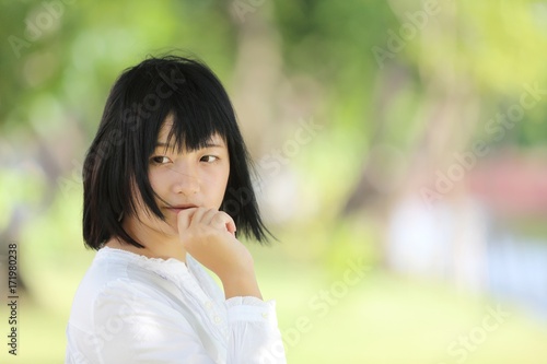 Asian young woman portrait with the tree background