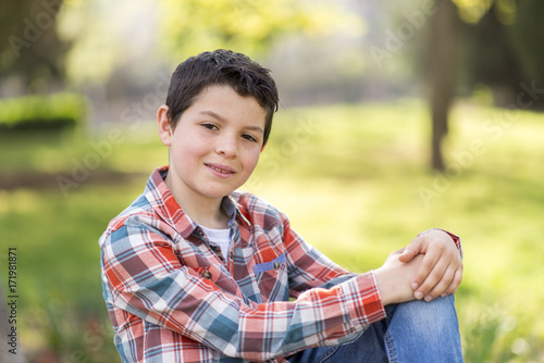 portrait of a casual teen boy, outdoors