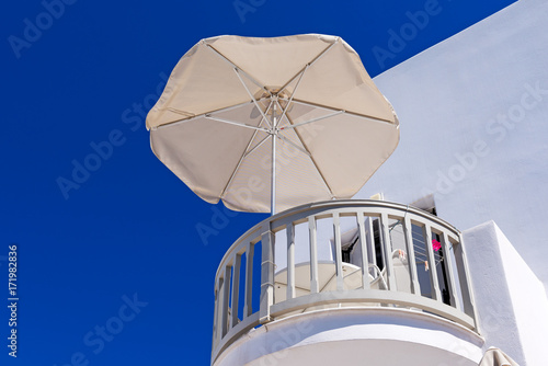 Parasol on the balcony under blue sky. Naxos island.  Cyclades  Greece. 