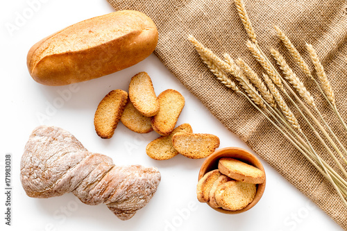 baking bread with wheat flour and ears on table white background top view
