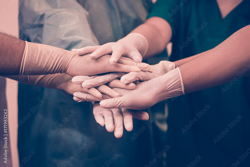 Doctors and nurses coordinate hands. Concept Teamwork Doctors and nurses coordinate hands. Concept Teamwork