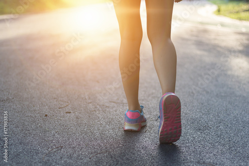 Runner woman running in the garden