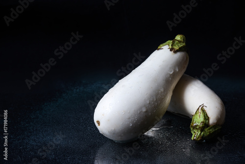 white eggplants on a dark background