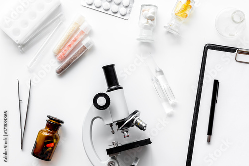 Do medcal tests. Microscope, tablet, pills and test tube on white background top view