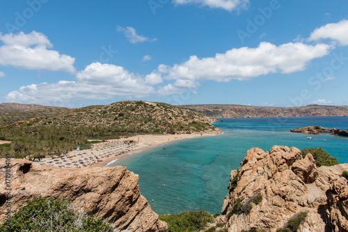 Beach of tourists in crete greece with palm trees