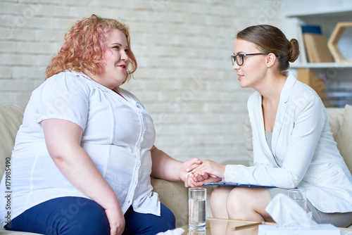Konstfotografi Obese young woman sharing problems with her highly professional psychologist, sh